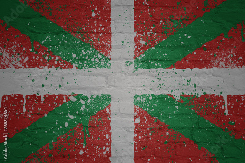 colorful painted big national flag of basque country on a massive brick wall