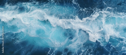 Capturing the beauty of nature, this image showcases a detailed close-up of a wave in the ocean with a serene blue sky in the background © TheWaterMeloonProjec