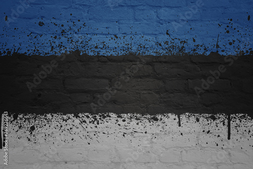 colorful painted big national flag of estonia on a massive brick wall