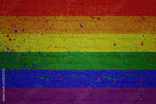 colorful painted big rainbow gay pride flag on a massive brick wall