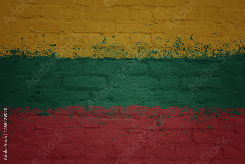 colorful painted big national flag of lithuania on a massive brick wall