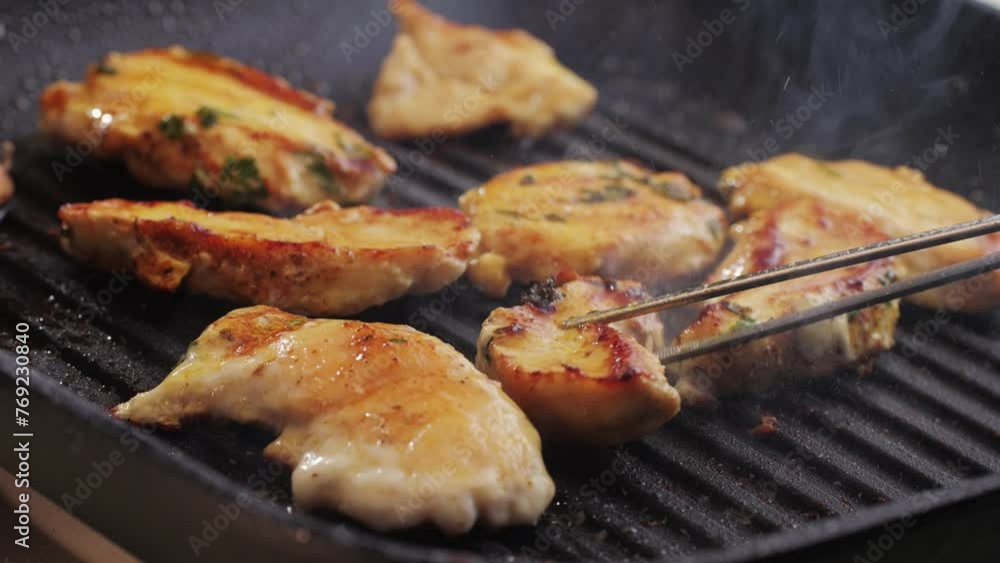 Cooking raw chicken meat in yellow turmeric spice with garlic and greens on grill close-up. Fry chicken slice on frying.pan Grilled chicken, duck, turkey kebab with vegetables. Cooking raw chicken meat in yellow turmeric spice with garlic and greens on grill close-up. Fry chicken slice on frying.pan Grilled chicken, duck, turkey kebab with vegetables.