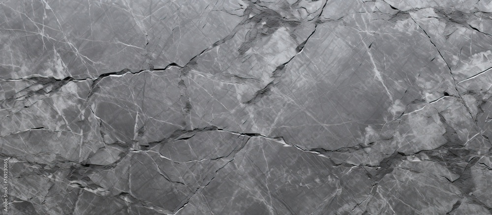 A close up of a gray marble texture resembling water ripples on a calm pond. The monochrome photography captures the intricate details of the landscape A close up of a gray marble texture resembling water ripples on a calm pond. The monochrome photography captures the intricate details of the landscape