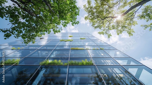 An eco-friendly building in a modern city setting, this sustainable glass office incorporates trees and green spaces to minimize heat and lower CO2 emissions.