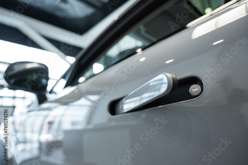 Close-up of an integrated handle in a car door. Fingerprint lock.  © Михаил Решетников