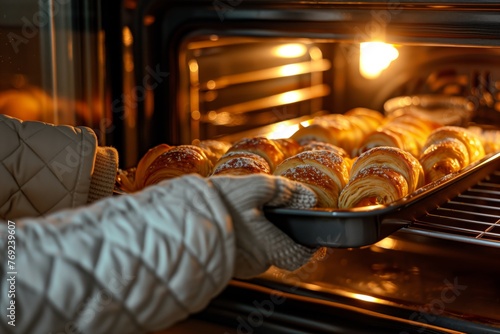 Freshly Baked Croissants Being Removed from Oven.