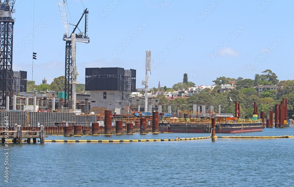 Building site and a large barge. The start of water front construction of the new Sydney Fish Market set to open in 2024