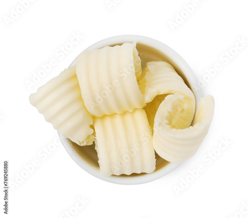 Tasty butter curls in bowl isolated on white, top view