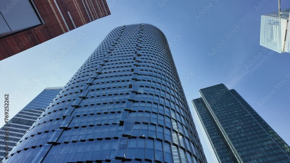 Low-angle pov of La Defense modern skyscrapers, Paris. First-person walking view Low-angle pov of La Defense modern skyscrapers, Paris. First-person walking view