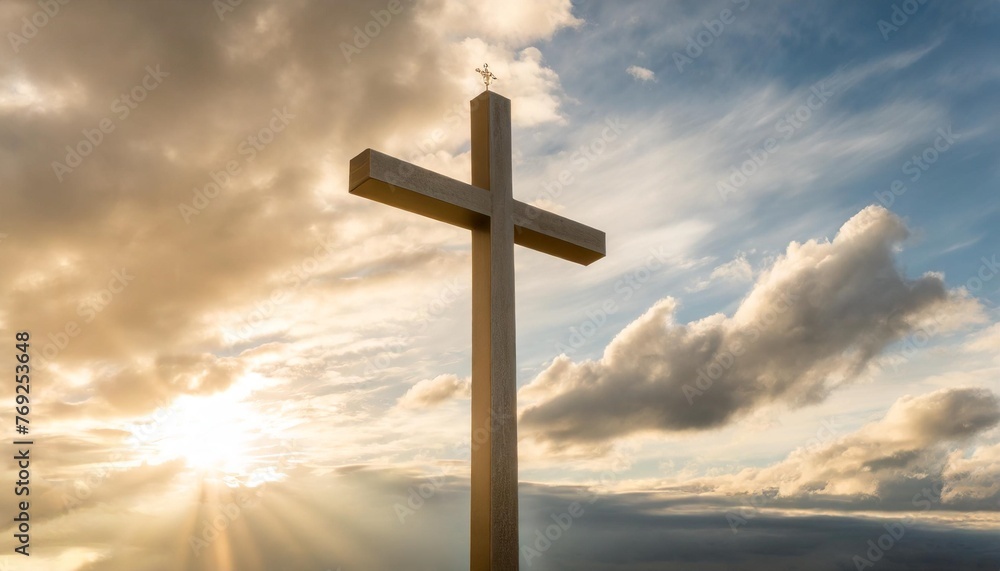 holy cross symbolizing the death and resurrection of jesus christ shrouded in light and clouds at sunset