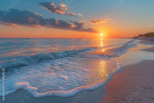 Soft waves wash ashore on a sandy beach during a breath-taking sunset with vibrant sky colors photo