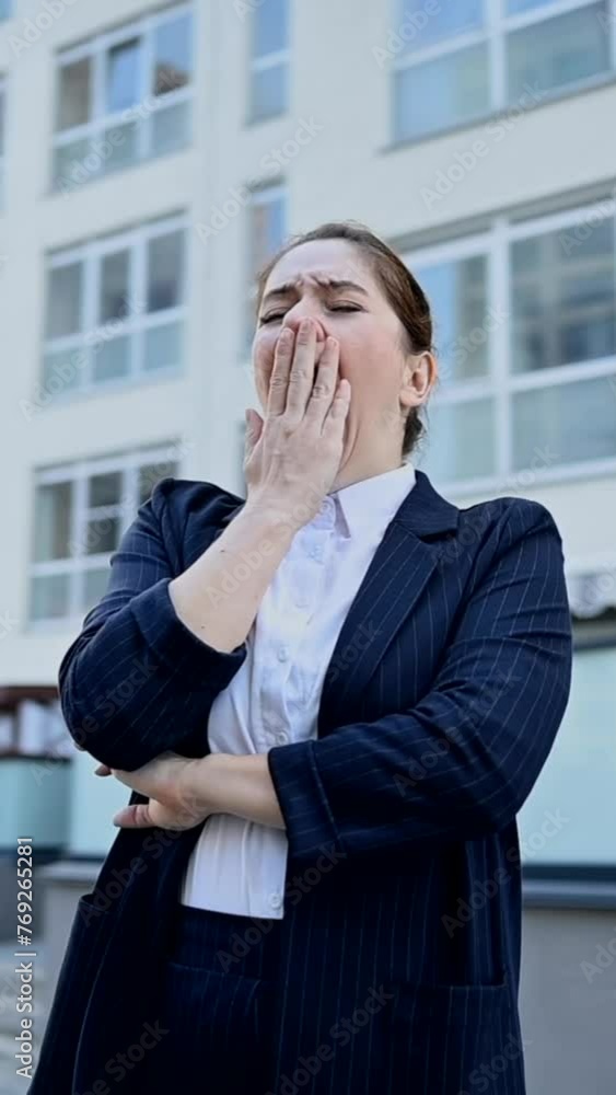 Vertical video 360 degrees. Caucasian business woman yawns outdoors. Vertical video 360 degrees. Caucasian business woman yawns outdoors.