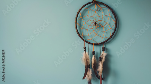 Cream crochet doily dream catcher close up on aquamarine textured background. Texture of concrete,copy space for text 