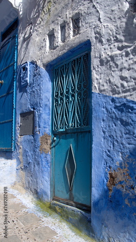 Blue, metal door in a blue wall in the medina in Chefchaouen, Morocco © Angela