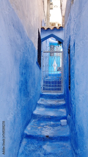 Steps leading to a grated entrance in the medina in Chefchaouen, Morocco © Angela