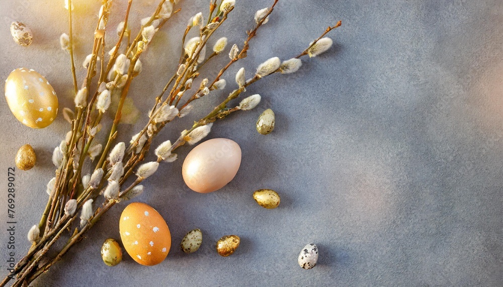 flat lay easter composition with a willow branch and eggs on a gray background