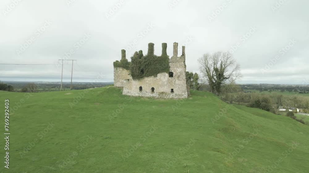 Carbury castle ruins on a grassy hill in kildare, ireland, under cloudy skies, aerial view Carbury castle ruins on a grassy hill in kildare, ireland, under cloudy skies, aerial view