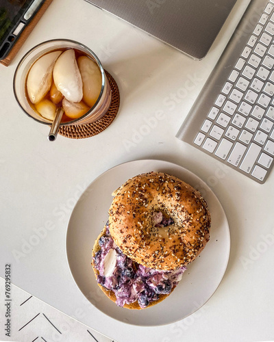cup of coffee bagel and a laptop