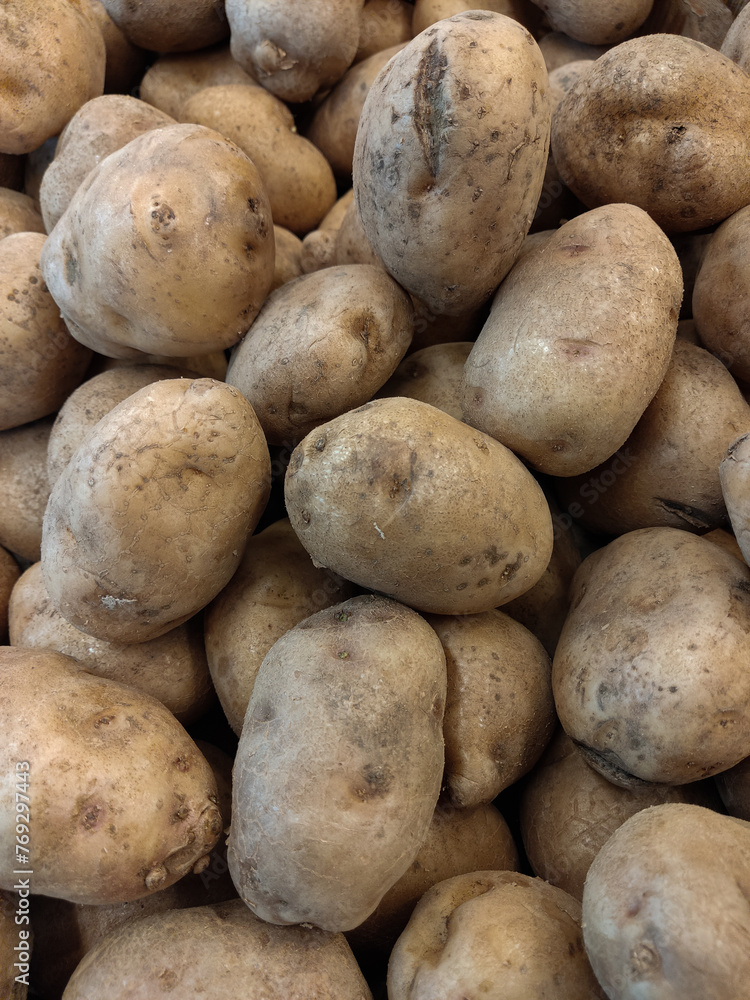 piles of fresh potatoes in the market