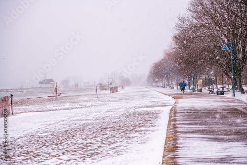 Photography jogger on wooden boardwalk beside beach runs away from camera  shot kew beach to