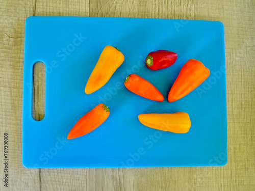 Colorful peppers on the table in the kitchen.