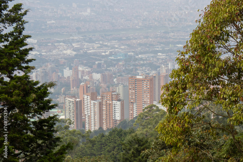 View of the city from the top of the mountain in Medellin Colombia, Cityscape View of Medellin through Forested Hills photo