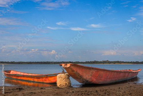 Peaceful Morning by the Lake with Vibrant Fishing Boats photo