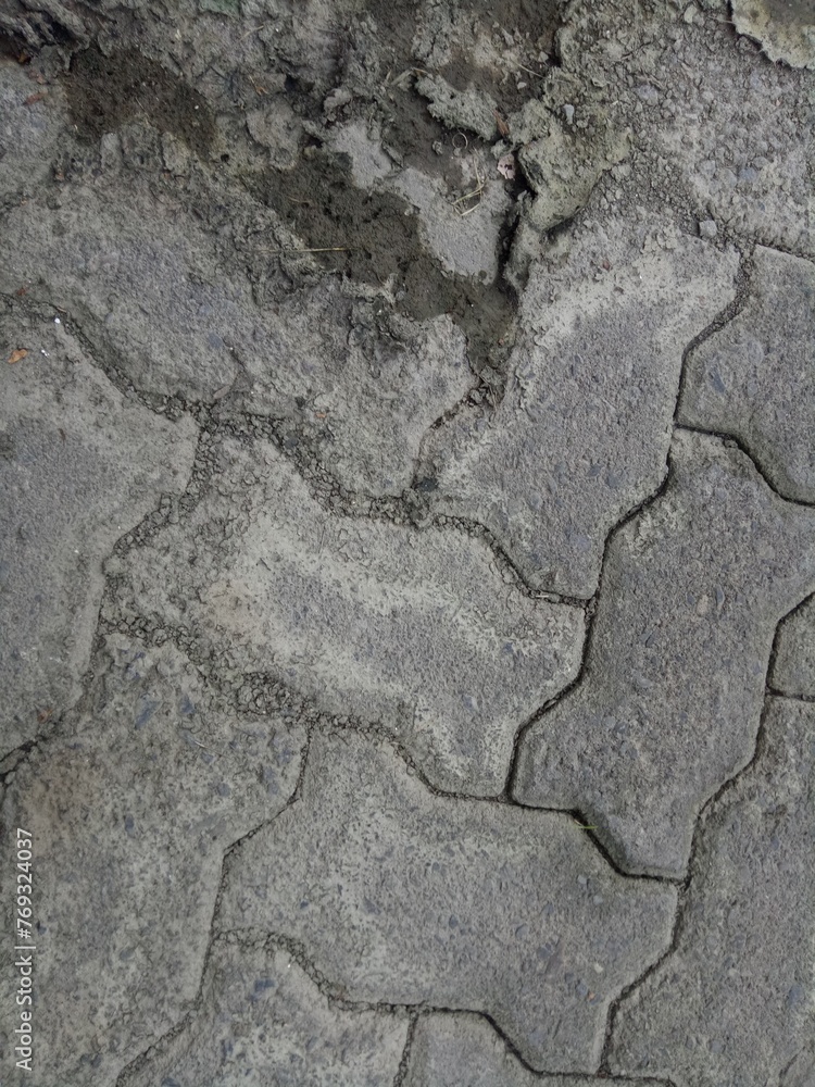 Obraz premium cracked and dirty brick paving roads
