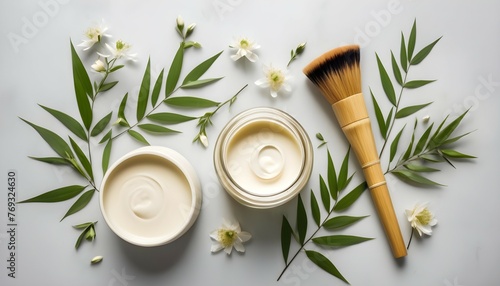 A creative flat lay arrangement of a bamboo brush nestled beside a jar of cream, accessorized with natural elements like leaves and flowers. photo