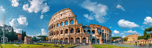 panoramic view of the Colosseum and Arch of Constantine in Rome, Italy with green grass on a sunny day © Kien