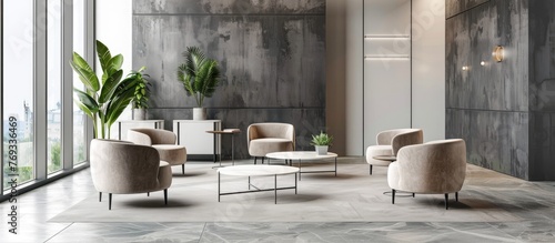 Stylish office waiting room with gray walls, tiled floor, white partition, and comfortable beige armchairs near round coffee tables.