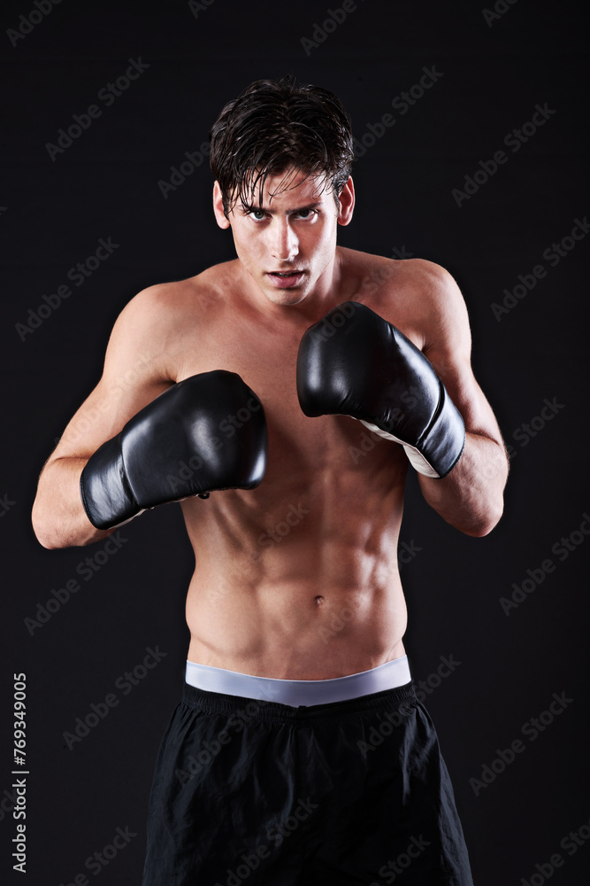 Man, portrait and boxing gloves in studio for workout fight or martial arts training or performance, black background or challenge. Male person, face and sports exercise or fitness, athlete or mockup