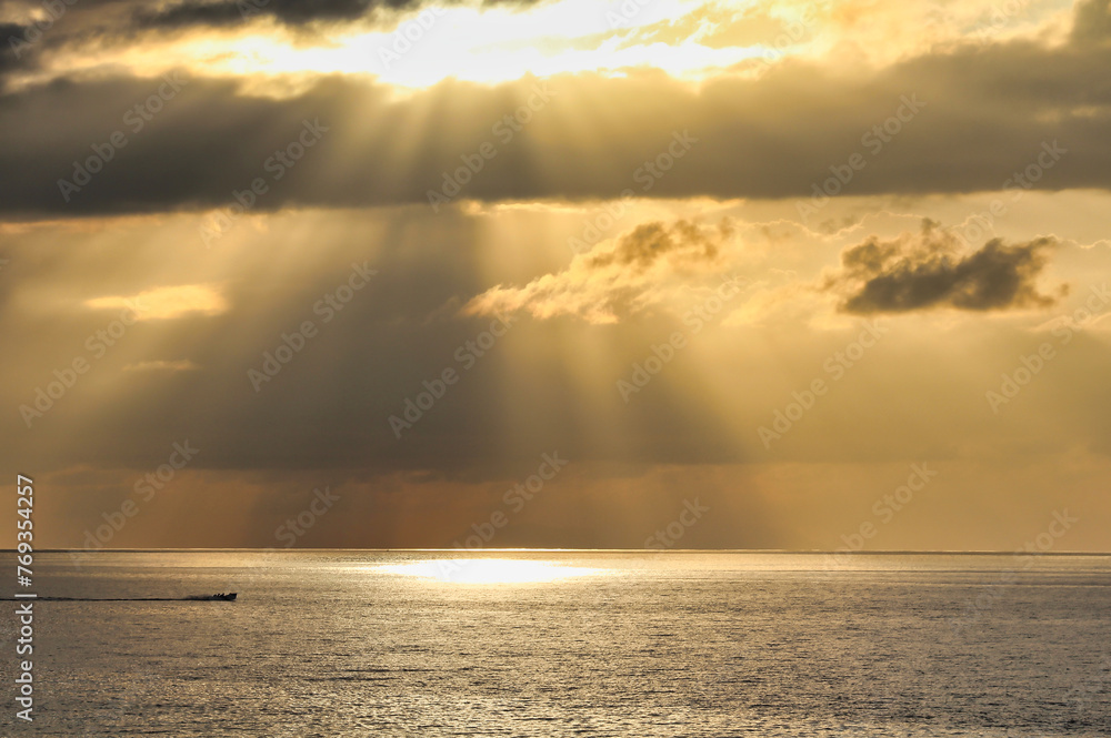 Sunset views over the Indian ocean on the channel between La Digue island and Mahe island off the coast of Seychelles
