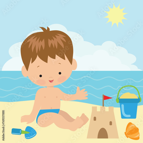 Toddler boy with sand bucket and scoop in hand on summer beach