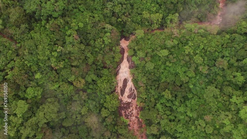 Drone top View of a beautiful Waterfall roaring and cascading down a rocky cliff photo