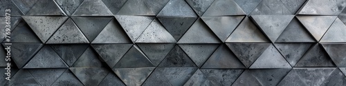 Detailed view of a geometric wall composed of triangular concrete tiles creating a mesmerizing pattern, background, wallpaper, banner