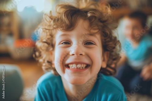 A joyful curly-haired child smiles brightly at the camera, surrounded by a loving family and a pet dog in a cozy home setting. AIG41