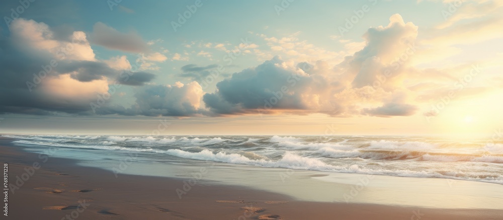 Cumulus clouds part as the sun shines over the ocean, creating a beautiful landscape with a glowing horizon and reflecting on the water