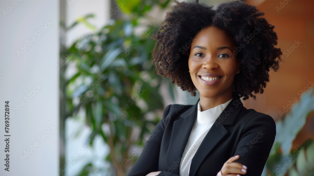 Smiling elegant confident young professional black afro american business woman , female proud leader, smart businesswoman lawyer or company manager executive looking at camera standing in office Smiling elegant confident young professional black afro american business woman , female proud leader, smart businesswoman lawyer or company manager executive looking at camera standing in office