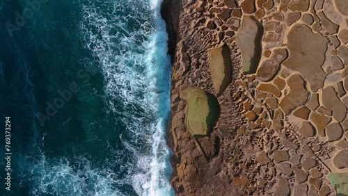 Gozo Island Salt Pans in 4K. Malta drone aerial seaside waves slow motion. photo
