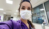 A nurse selfie wearing a white face mask and a stethoscope around her neck