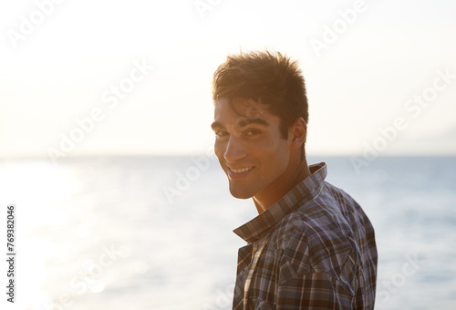 Happy, beach and portrait of man in summer for vacation, holiday and weekend outdoors. Nature, travel and face of person with smile for relaxing, adventure and freedom by ocean on tropical island