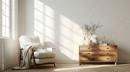 interior of a living room with an armchair a coffee table and a chest of drawers against a light wall