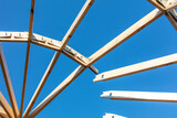 Wooden roof in a yurt against a blue sky