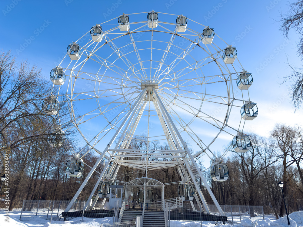 Ferris wheel attraction against a blue sky
