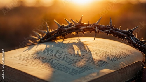 The shadow of a Crown of Thorns projects onto the pages of an open Bible at sunset