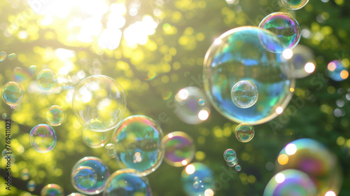 Sunlit soap bubbles with green foliage backdrop - Soap bubbles are beautifully contrasted by the green foliage in the sunny, natural setting of this image