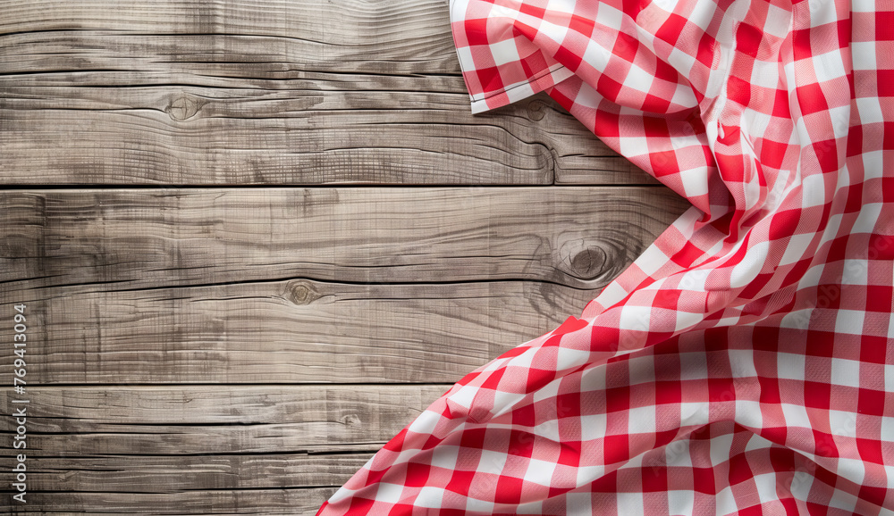 Red and White Gingham Cloth on Wooden Background. A red and white gingham cloth elegantly sprawls across a natural wooden plank background, invoking a rustic yet homely vibe. Red and White Gingham Cloth on Wooden Background. A red and white gingham cloth elegantly sprawls across a natural wooden plank background, invoking a rustic yet homely vibe.