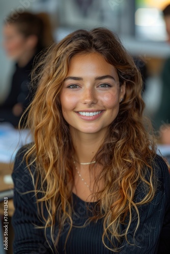 Portrait of a young woman with natural makeup and wavy hair.