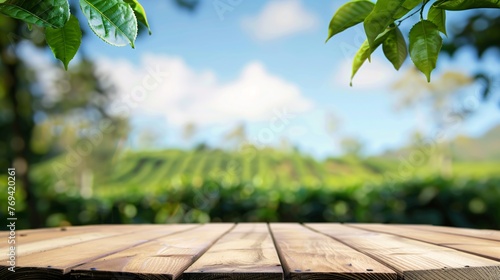 Circular wooden surface with obscured view of tea farm scenery under blue sky and hazy foliage frame Display idea with organic backdrop.